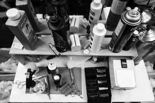 Shelves of barbershop tonics, oils, and supplies.