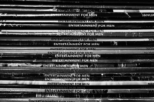 A neat stack of vintage magazines, spines reading 'Entertainment for Men.'